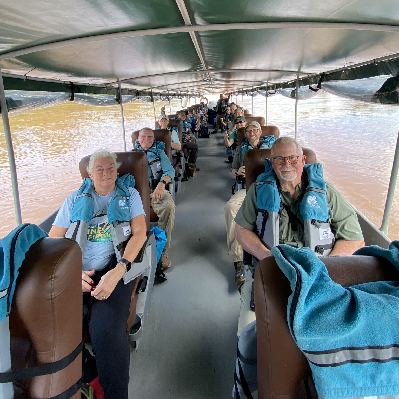 A group of birders seated on a boat during a canoe ride on the Napa River, enjoying birdwatching in Ecuador.